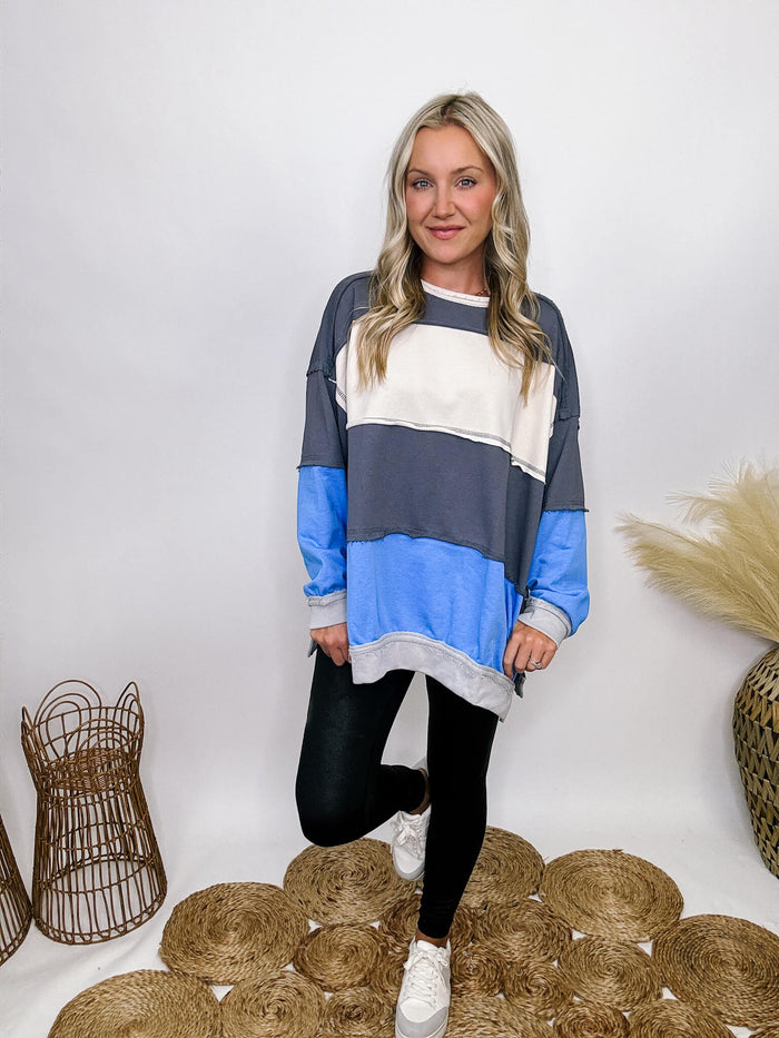 She + Sky blue, white, and grey colorblock oversized sweatshirt with pockets and exposed seam details.