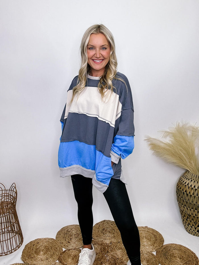 She + Sky blue, white, and grey colorblock oversized sweatshirt with pockets and exposed seam details.