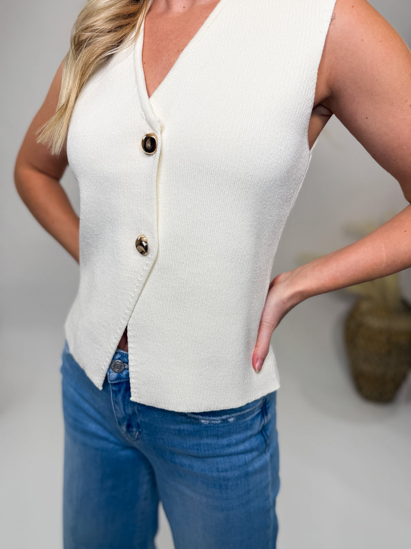 She & Sky cream asymmetrical sweater vest with gold buttons, soft stretchy material, perfect for spring and casual chic outfits.