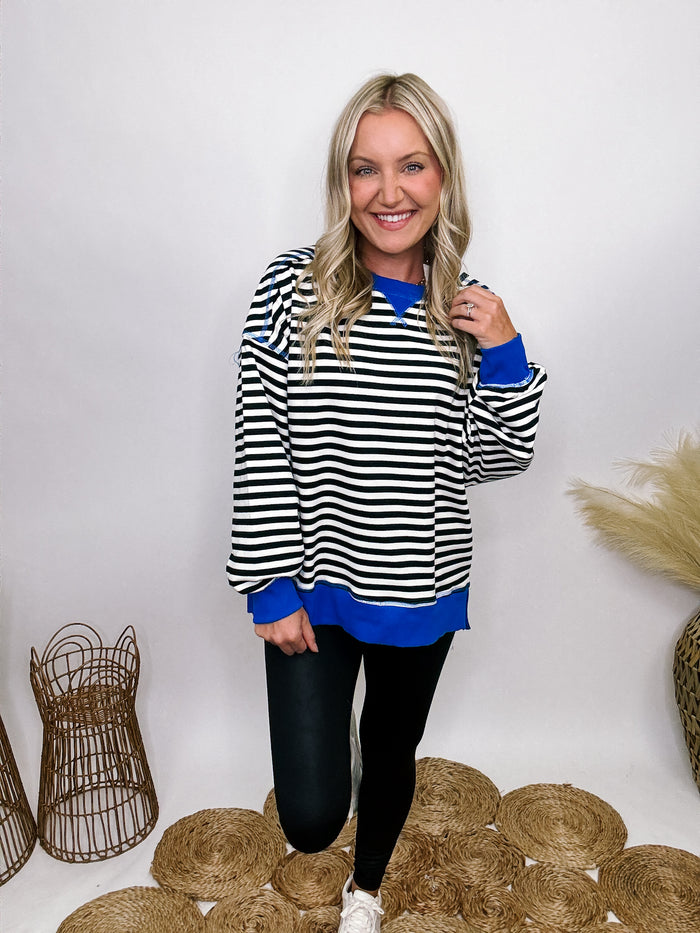 Very J Black, white, and blue striped crewneck pullover with side slits and relaxed fit.