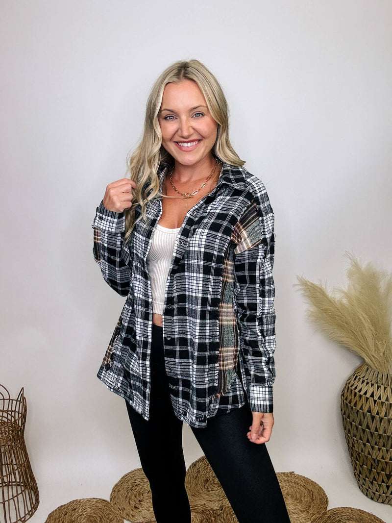 Black and white plaid flannel shirt with subtle olive, featuring frayed hem details, button-down front, and long sleeves, styled with a basic tank or graphic tee.