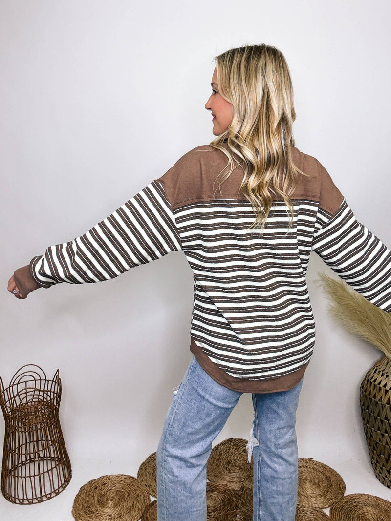 Very J Mocha striped collared pullover with V-neckline and button details, oversized fit, soft stretchy material, drop shoulder, and round hem, ideal for early autumn.