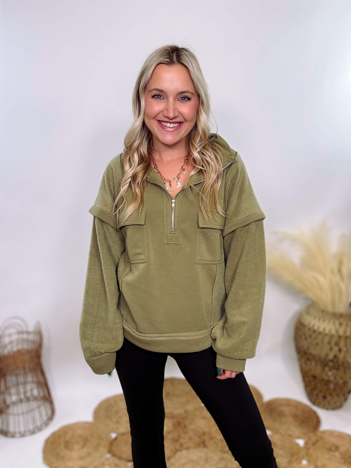 Olive mock neck quarter zip oversized sweatshirt with raw edge details, exposed seams, and cozy fleece fabric. Features a relaxed fit, patch pockets, and long sleeves with drop shoulders