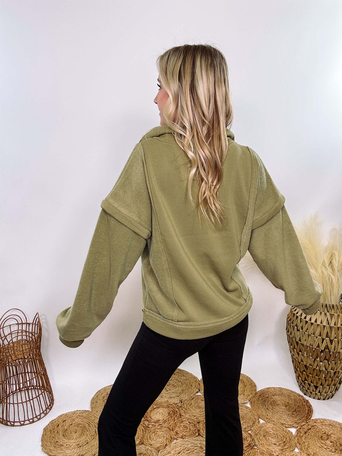 Olive mock neck quarter zip oversized sweatshirt with raw edge details, exposed seams, and cozy fleece fabric. Features a relaxed fit, patch pockets, and long sleeves with drop shoulders