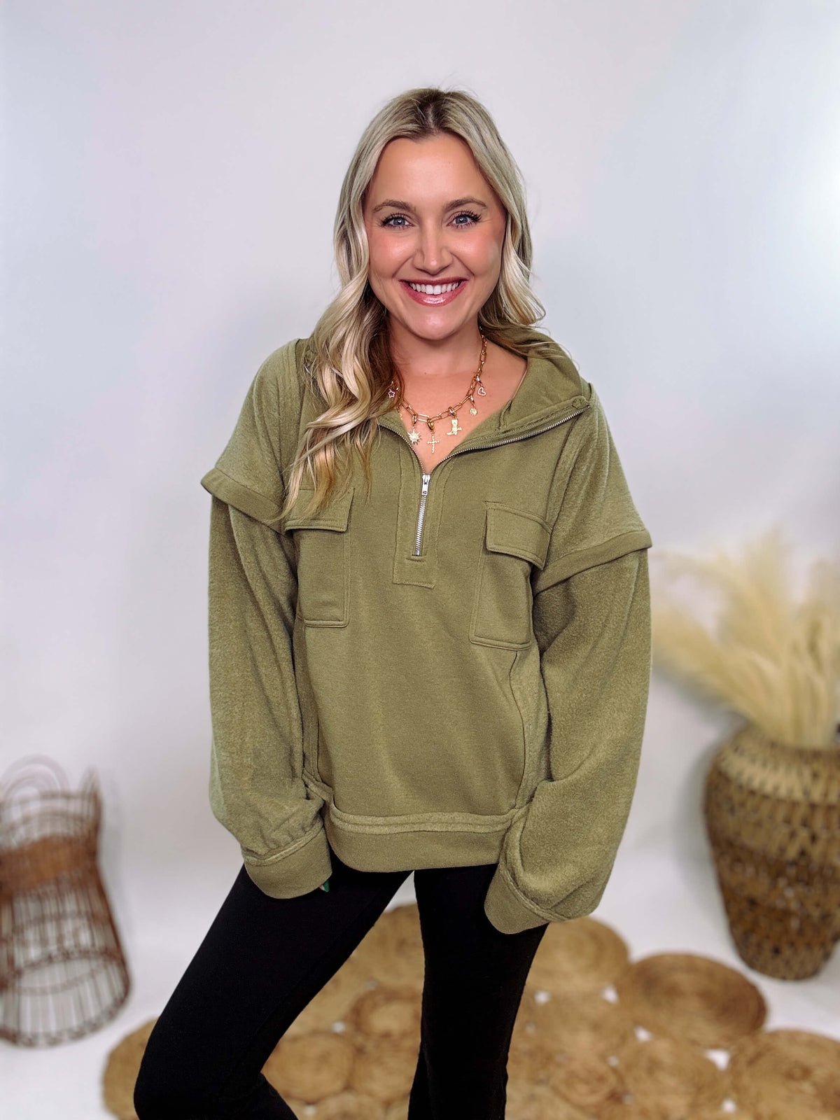 Olive mock neck quarter zip oversized sweatshirt with raw edge details, exposed seams, and cozy fleece fabric. Features a relaxed fit, patch pockets, and long sleeves with drop shoulders