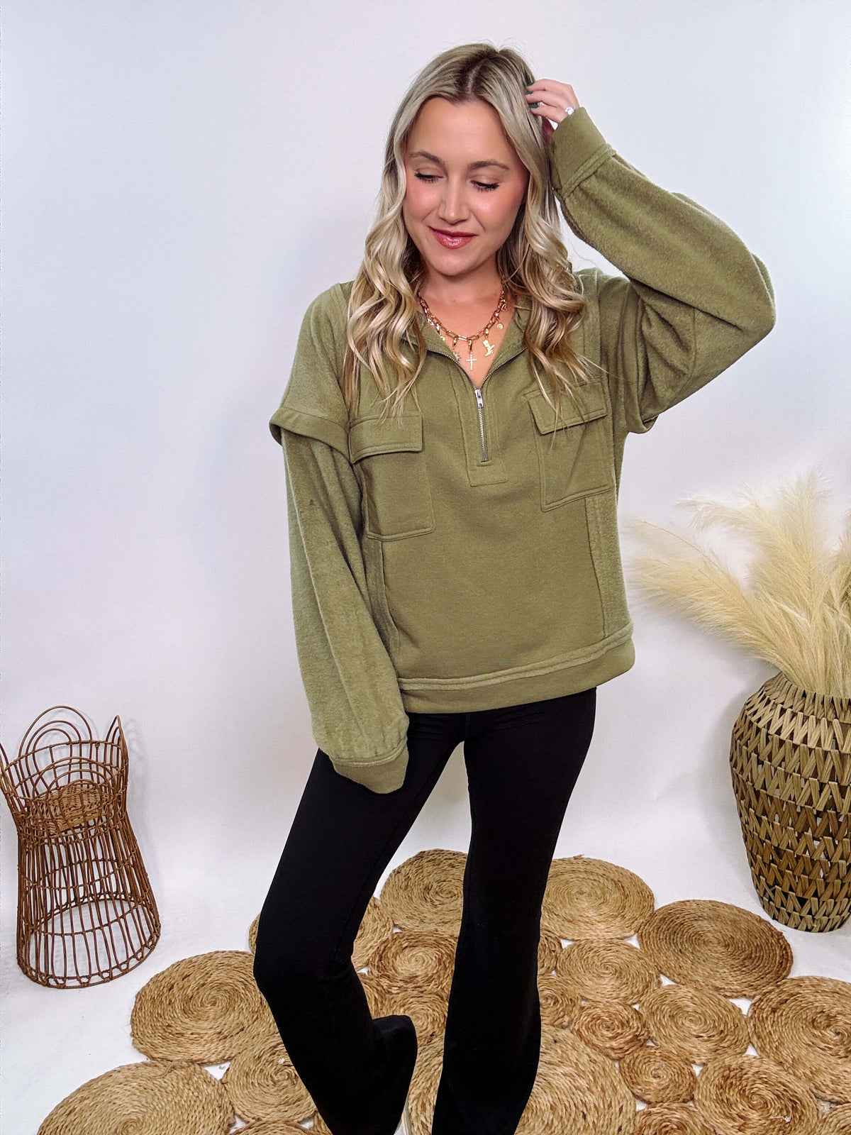 Olive mock neck quarter zip oversized sweatshirt with raw edge details, exposed seams, and cozy fleece fabric. Features a relaxed fit, patch pockets, and long sleeves with drop shoulders