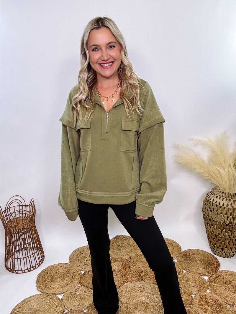 Olive mock neck quarter zip oversized sweatshirt with raw edge details, exposed seams, and cozy fleece fabric. Features a relaxed fit, patch pockets, and long sleeves with drop shoulders