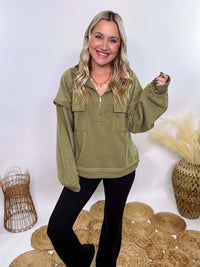 Olive mock neck quarter zip oversized sweatshirt with raw edge details, exposed seams, and cozy fleece fabric. Features a relaxed fit, patch pockets, and long sleeves with drop shoulders