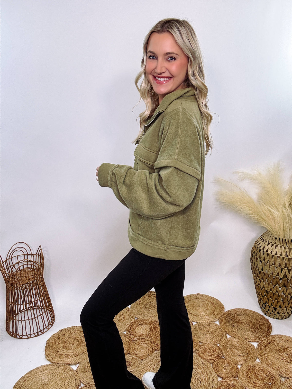 Olive mock neck quarter zip oversized sweatshirt with raw edge details, exposed seams, and cozy fleece fabric. Features a relaxed fit, patch pockets, and long sleeves with drop shoulders