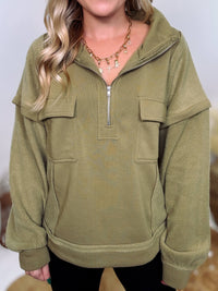 Olive mock neck quarter zip oversized sweatshirt with raw edge details, exposed seams, and cozy fleece fabric. Features a relaxed fit, patch pockets, and long sleeves with drop shoulders