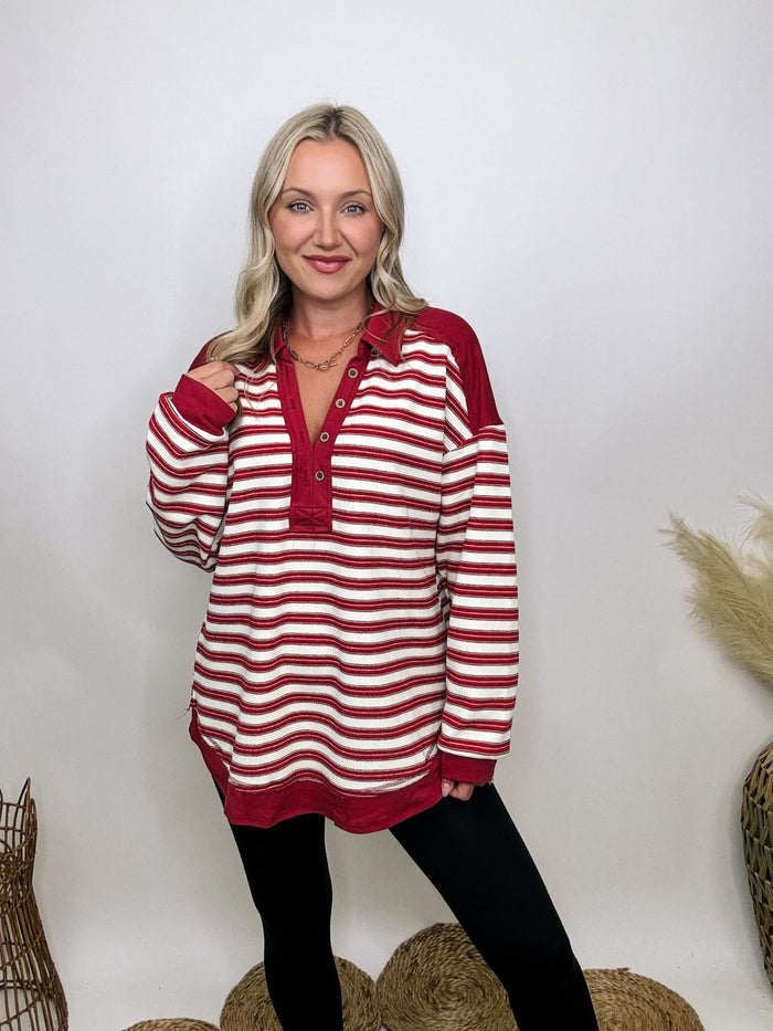 Very J Red striped collared pullover with V-neckline and button details, oversized fit, soft stretchy material, drop shoulder, and round hem, perfect for early autumn.
