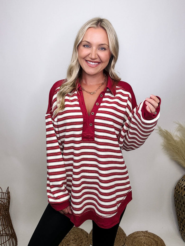 Very J Red striped collared pullover with V-neckline and button details, oversized fit, soft stretchy material, drop shoulder, and round hem, perfect for early autumn.
