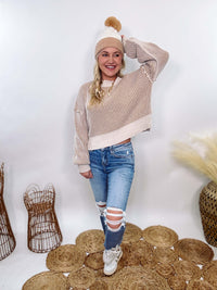 Very J Two-tone neutral ribbed sweater featuring a cream body with light brown ribbed detailing, round neck, and loose fit. Made from 100% polyester with a soft, non-scratchy feel. Styled with a neutral beanie and kick flare denim for a cozy winter look.