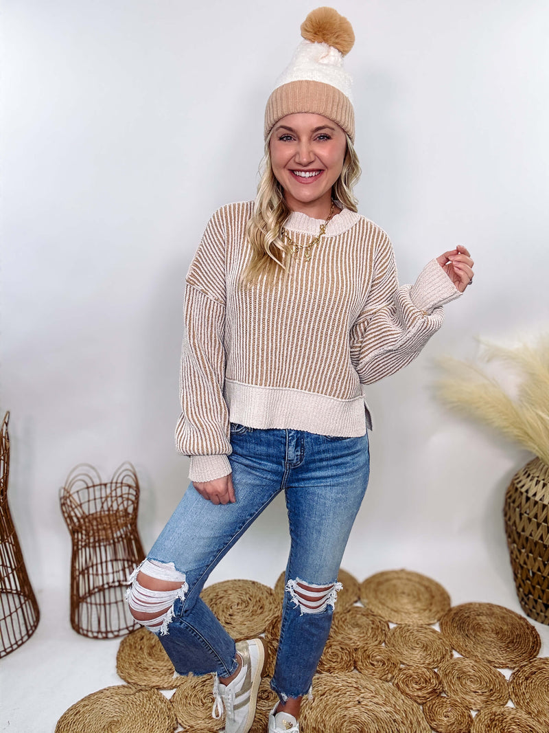 Very J Two-tone neutral ribbed sweater featuring a cream body with light brown ribbed detailing, round neck, and loose fit. Made from 100% polyester with a soft, non-scratchy feel. Styled with a neutral beanie and kick flare denim for a cozy winter look.