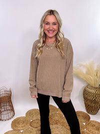 Washed Brown Oversized Ribbed Long Sleeve Top with Soft Texture and Exposed Stitch Details – Cozy and Stylish Layering Piece for Fall and Winter. Perfect for Casual Outfits, Lounging, or Pairing with Jackets.