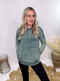 Zenana Ash Jade Green Acid Washed Raw Hem Pocket Pullover with raw edge seams, chest and side pockets, ribbed wrist and hem detailing, and a cozy relaxed fit.