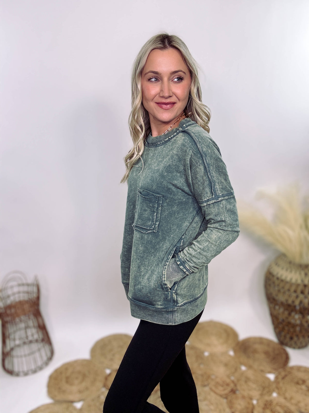 Zenana Ash Jade Green Acid Washed Raw Hem Pocket Pullover with raw edge seams, chest and side pockets, ribbed wrist and hem detailing, and a cozy relaxed fit.