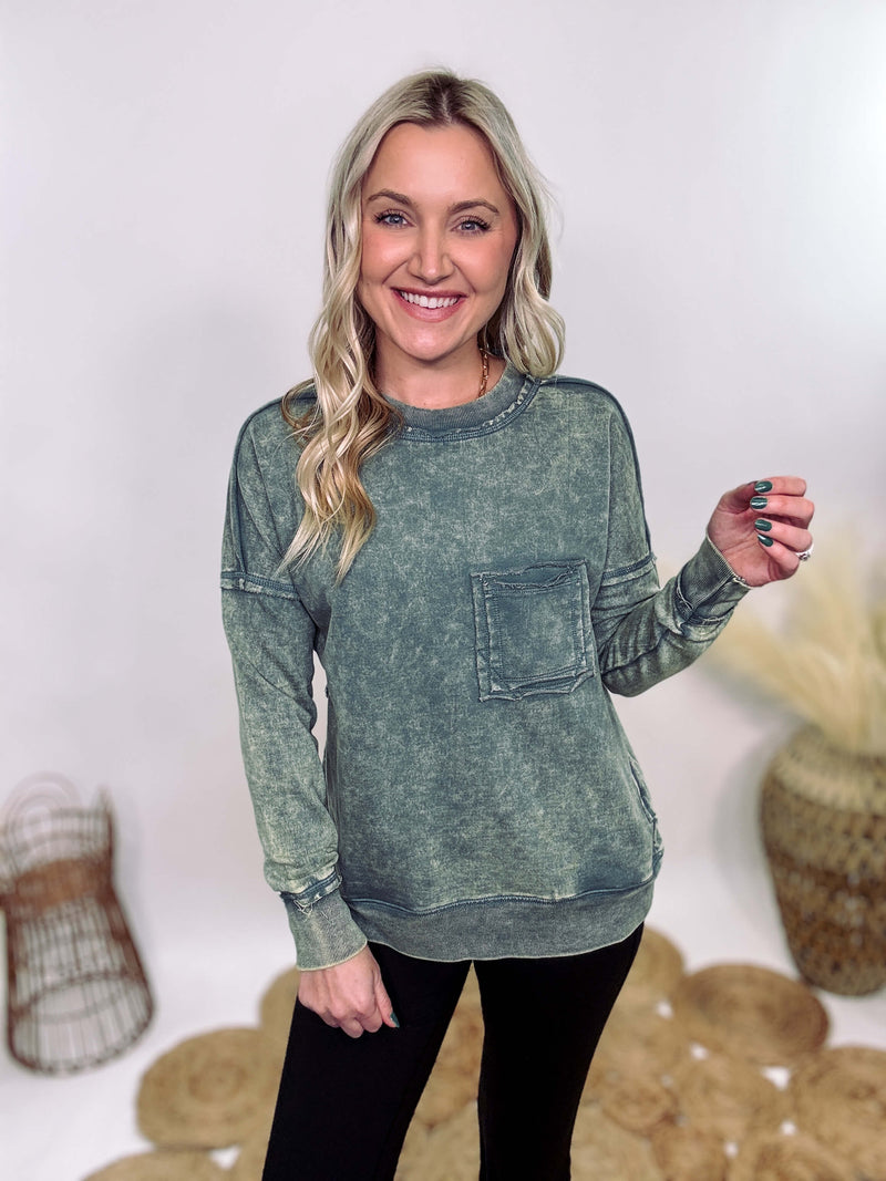 Zenana Ash Jade Green Acid Washed Raw Hem Pocket Pullover with raw edge seams, chest and side pockets, ribbed wrist and hem detailing, and a cozy relaxed fit.