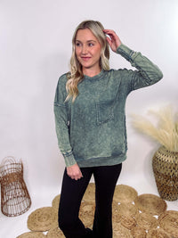 Zenana Ash Jade Green Acid Washed Raw Hem Pocket Pullover with raw edge seams, chest and side pockets, ribbed wrist and hem detailing, and a cozy relaxed fit.