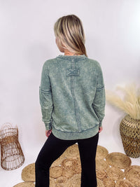 Zenana Ash Jade Green Acid Washed Raw Hem Pocket Pullover with raw edge seams, chest and side pockets, ribbed wrist and hem detailing, and a cozy relaxed fit.