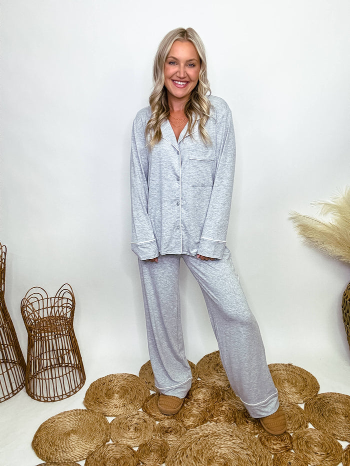 Zenana heather grey pajama set featuring a button-down long sleeve shirt and long pants with an elastic waist, true to size relaxed fit. Model Brooke is 5'4" wearing size small.