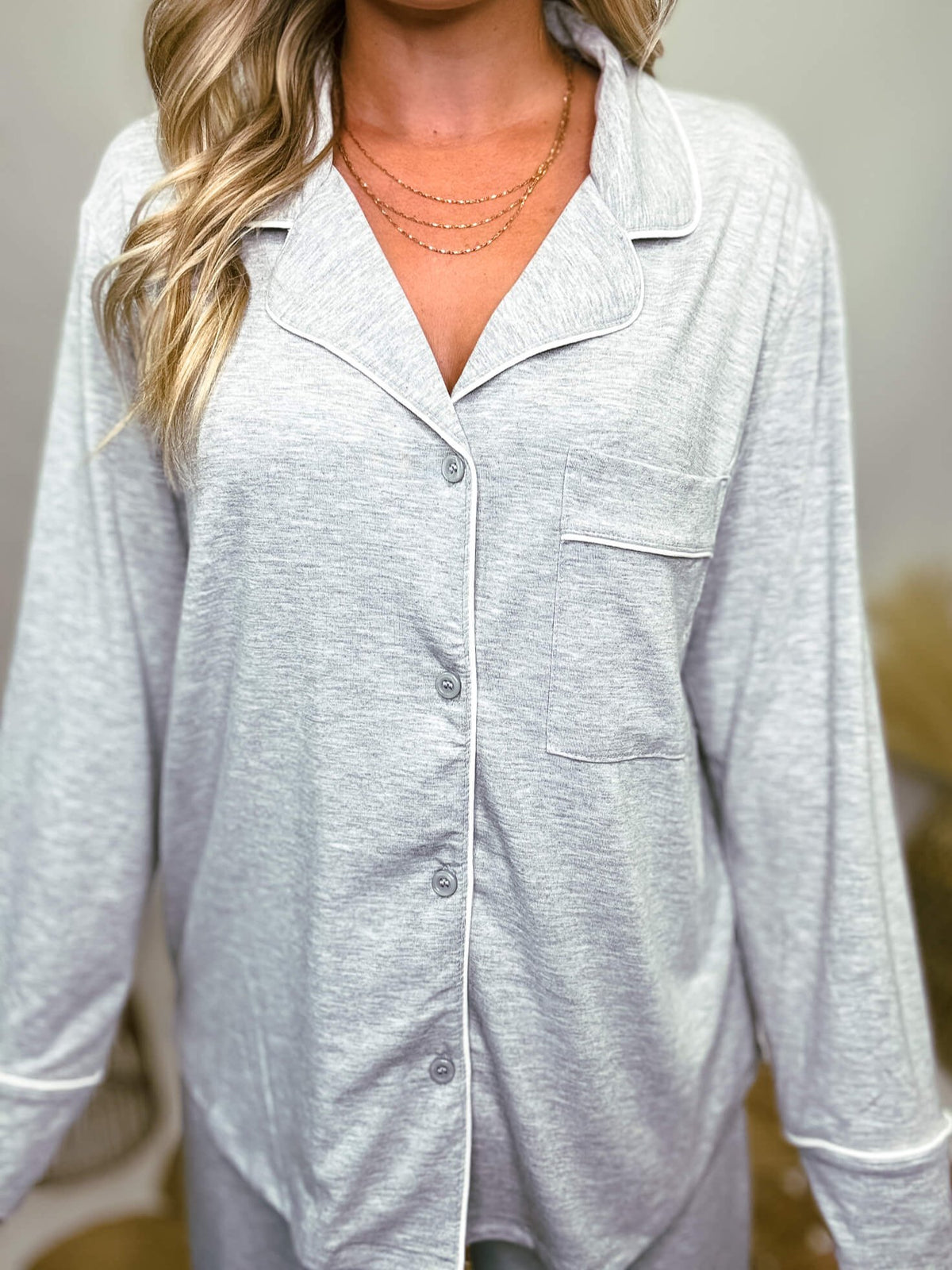 Zenana heather grey pajama set featuring a button-down long sleeve shirt and long pants with an elastic waist, true to size relaxed fit. Model Brooke is 5'4" wearing size small.